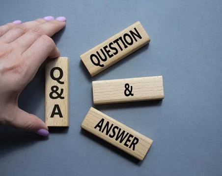 Q and A - Question and Answer. Wooden cubes with words Q and A. Businessman.. Stock Photos