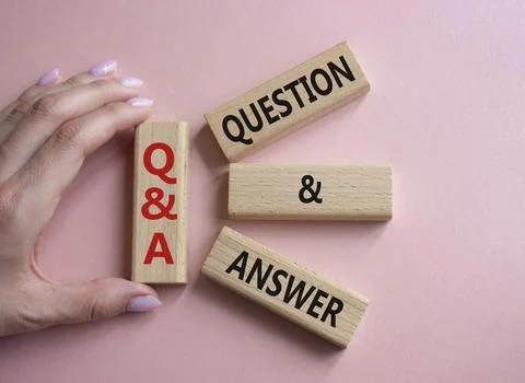 Q and A - Question and Answer. Wooden cubes with words Q and A. Businessman.. Stock Photos