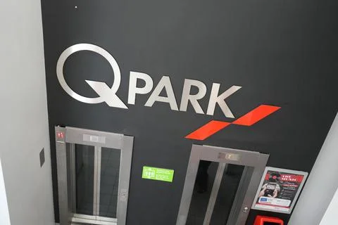Q-park Logo And Elevators In A Parking Garage, Sheffield, England. Stock Photos