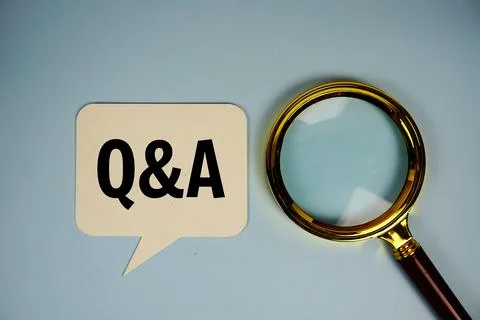 Q&amp;A (Question and Answer) text on speech bluble with alarm clock top view o.. Stock Photos