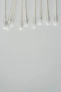 Q-tip, or cotton bud swab top view on vertical white background with blank em Stock Photos