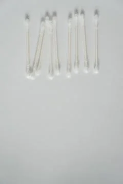 Q-tip, or cotton bud swab top view on vertical white background with blank em Stock Photos