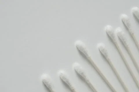 Q-tip, or cotton bud swab top view on white background with horizontal blank  Stock Photos