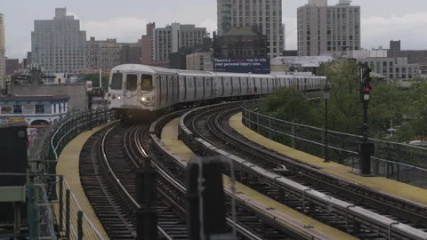 Q Train riding on tracks above ground in Brooklyn New York City Video stock 335415441