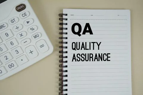 QA Abbreviations of Quality Assurance text with calculator phrase of busine.. Stock Photos