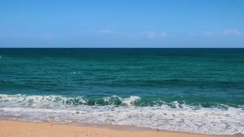 Qalhat, Oman Turquoise Waves on a Sandy Beach Stock Footage 318647772