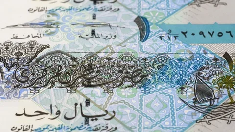 Qatar 1 riyal banknotes tracking. Qatari currency. Slider shot, low angle. 4K Stock Footage 125991580