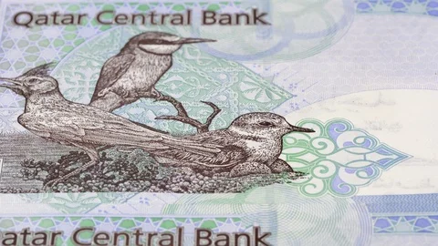Qatar 1 riyal banknotes tracking. Qatari currency. Slider shot, low angle. 4K Stock Footage 125992267