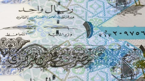 Qatar 1 riyal notes tracking. Qatari money. Slider shot, low angle. 4K Stock Footage 125991603