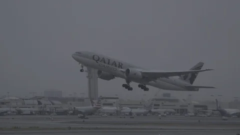 Qatar Freight Cargo Boeing Jumbojet Airplane Takeoff LAX Airport Terminal Fog Stock Footage 90933719
