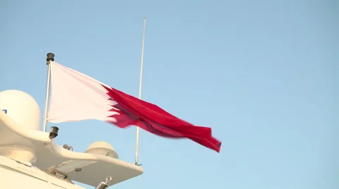 Qatari flag waves on a boat docked in Lusail City, Qatar Stock Footage 58655976