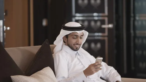 Qatari man messaging on mobile. Stock Footage 119389550