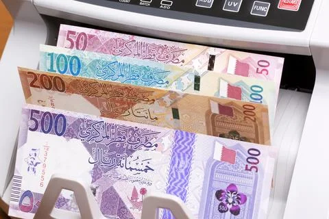 Qatari riyal in the counting machine Stock Photos