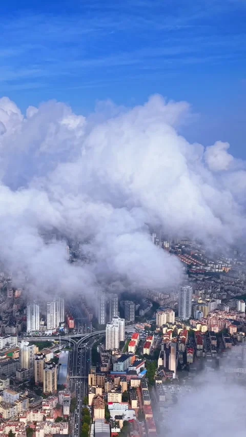 Qingdao City Skyline Emerging Through Dramatic Rolling Clouds Stock Footage 330885367