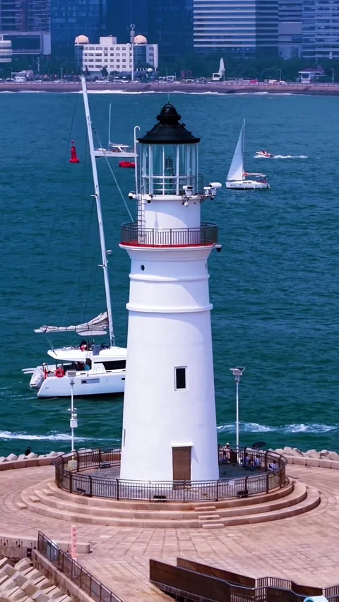 Qingdao Lighthouse at Olympic Sailing Center with Cityscape and Boats Stock Footage 330849074