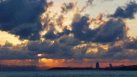 Qingdao Sunset Dramatic Sky Tyndall Crepuscular Rays Over Sea Handheld Wide Video stock 347995791