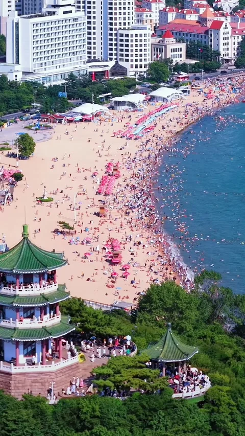 Qingdao's First Beach: Aerial View of Vibrant Summer Crowd Stock Footage 330650046