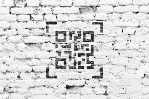 QR code concept. Encoded web link on a brick wall. 库存照片