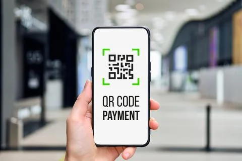QR code concept. Icon for payment in a smartphone in a person hand. Stock Photos