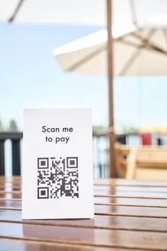 QR code for contactless, cashless payment, placed on the table of a restaurant Stock Photos