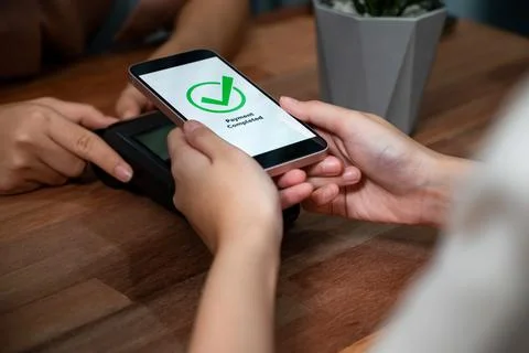 QR code is displayed on screen for cashless payment scanning. Enthusiastic Stock Photos