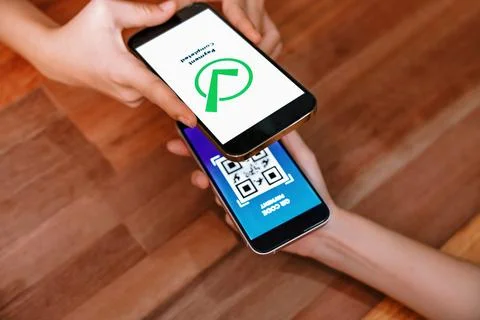 QR code is displayed on screen for cashless payment scanning. Enthusiastic Stock Photos