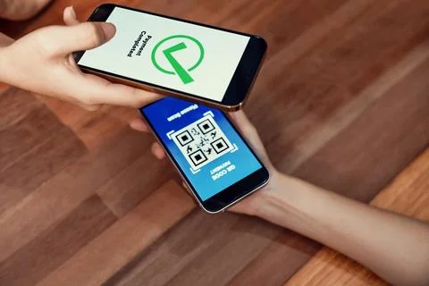 QR code is displayed on screen for cashless payment scanning. Enthusiastic Stock Photos