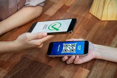 QR code is displayed on screen for cashless payment scanning. Enthusiastic Stock Photos