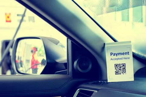 QR code payment tag with blurry image on wing mirror of staff  in gas station 스톡 사진