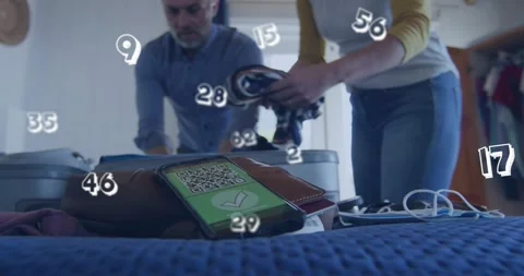 QR-code phone appearing, couple wearing jeans packing clothes into suitcase on Stock Footage 332289395