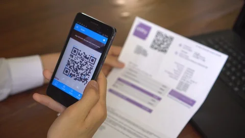 QR codes to pay bills through mobile technology Stock Footage 129659970