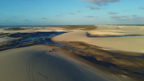 Quad Bikes Crossing Lençóis Maranhenses With Long Sunset Shadows Stock Footage 339804553