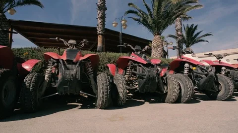 Quad bikes in a row with background palm trees Stock Footage 86487296