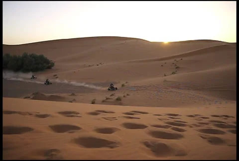 Quad Bikes Speed through the Sand Dunes Stock Footage 34287941