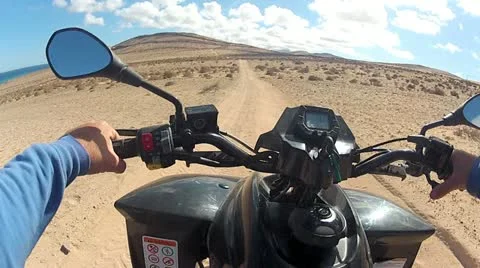 Quad Driving Across The Desert Front View 2 Stock-Footage 11017607