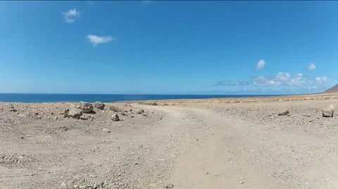 Quad Driving Across The Desert Low View Video stock 11017604