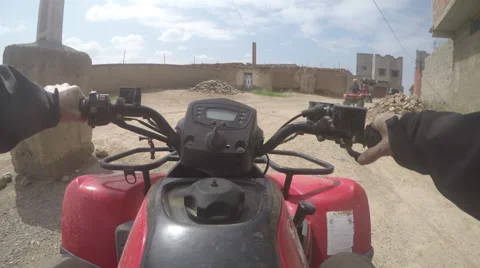 Quad driving in Morocco thru Berber village Stock Footage 50620749