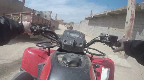 Quad driving in morocco thru berber village 2 Stock Footage 50622302