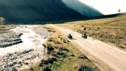 Quad ride in the mountains, top view, tilt-shift Video stock 98084480