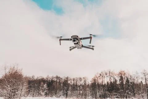 A quadcopter with a built-in camera flies into the sky, captures video footag Fotos de archivo