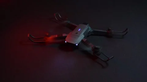 Quadcopter in a dark room illuminated by red light Stock Footage 302959946
