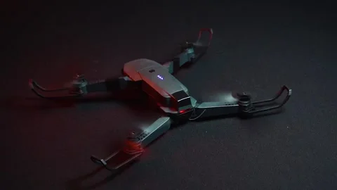 Quadcopter in a dark room illuminated by red light 스톡 동영상 302959947