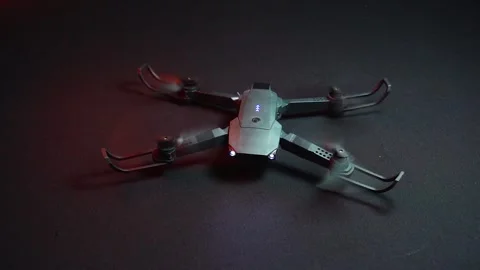Quadcopter in a dark room illuminated by red light 스톡 동영상 302959975