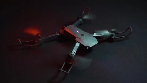 Quadcopter in a dark room illuminated by red light Stock-Footage 302959994