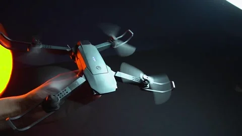 Quadcopter in a dark room illuminated by red light 스톡 동영상 302960045