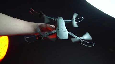 Quadcopter in a dark room illuminated by red light Vidéo 302960063