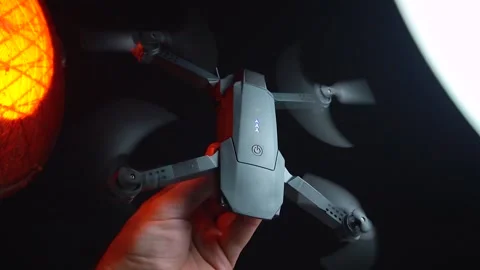 Quadcopter in a dark room illuminated by red light Stock Footage 302960117