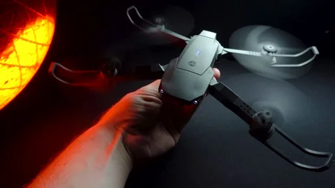 Quadcopter in a dark room illuminated by red light 스톡 동영상 302960156