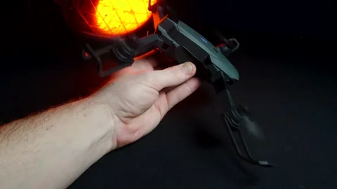 Quadcopter in a dark room illuminated by red light Vídeo Stock 302960207