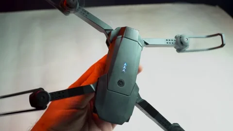 Quadcopter in a dark room illuminated by red light Stockbeeldmateriaal 302960262